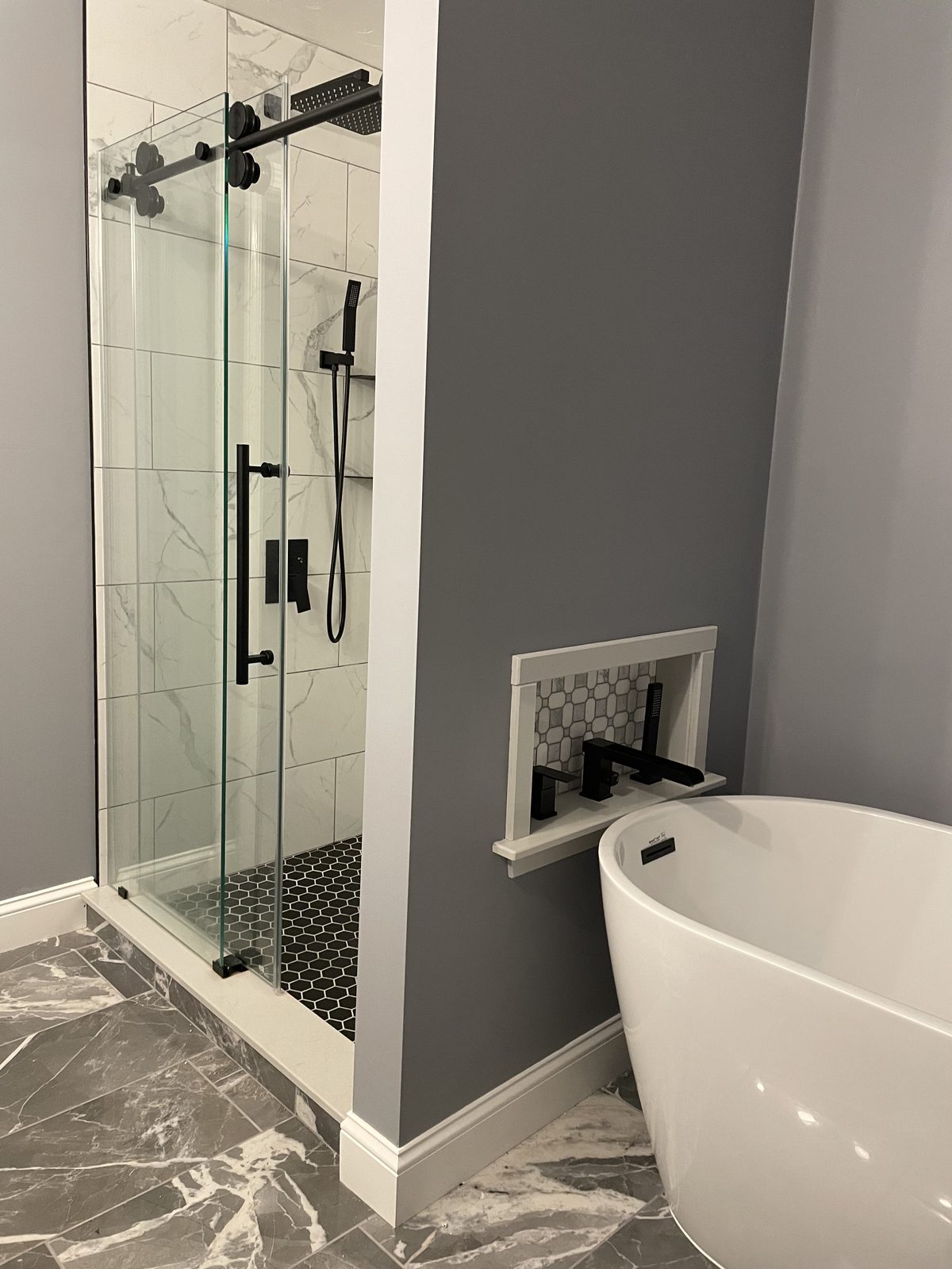 Primary bath remodel with a glass walk-in shower and freestanding tub