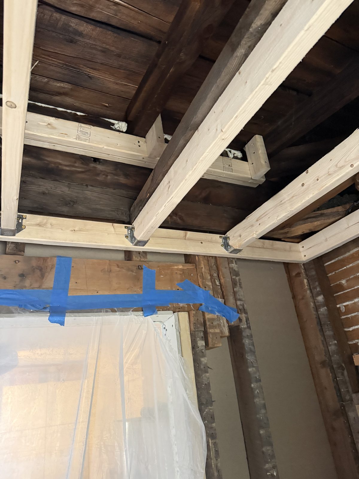 New structural beam and joist framing during a renovation